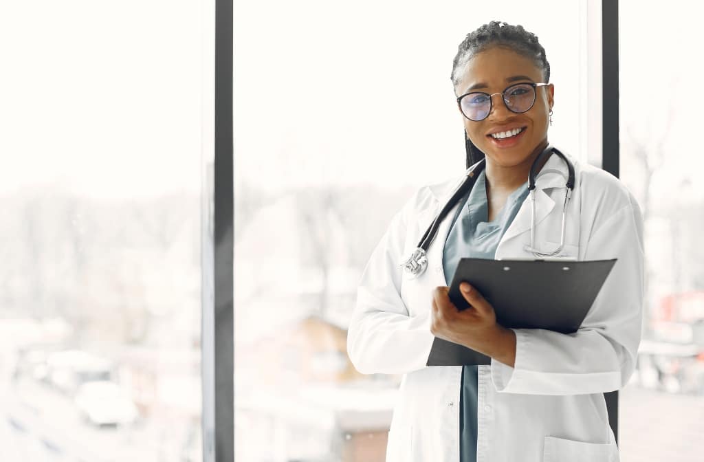 Female physician holding a clipboard.