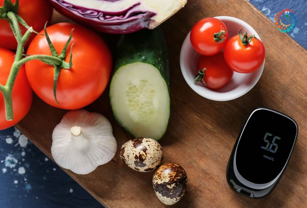 Tomatoes, garlic, and other vegetables on cutting board with glucose monitor