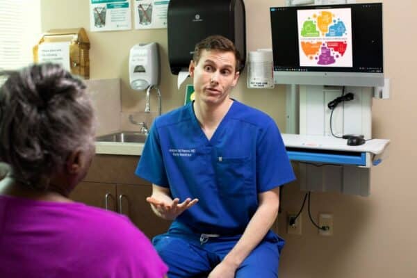 Dr. Andrew Nance talking to a patient in his office