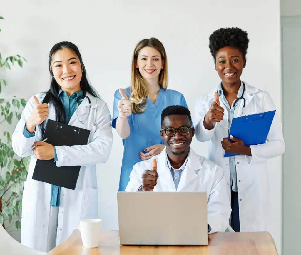 Diverse team of healthcare professionals giving the thumbs up